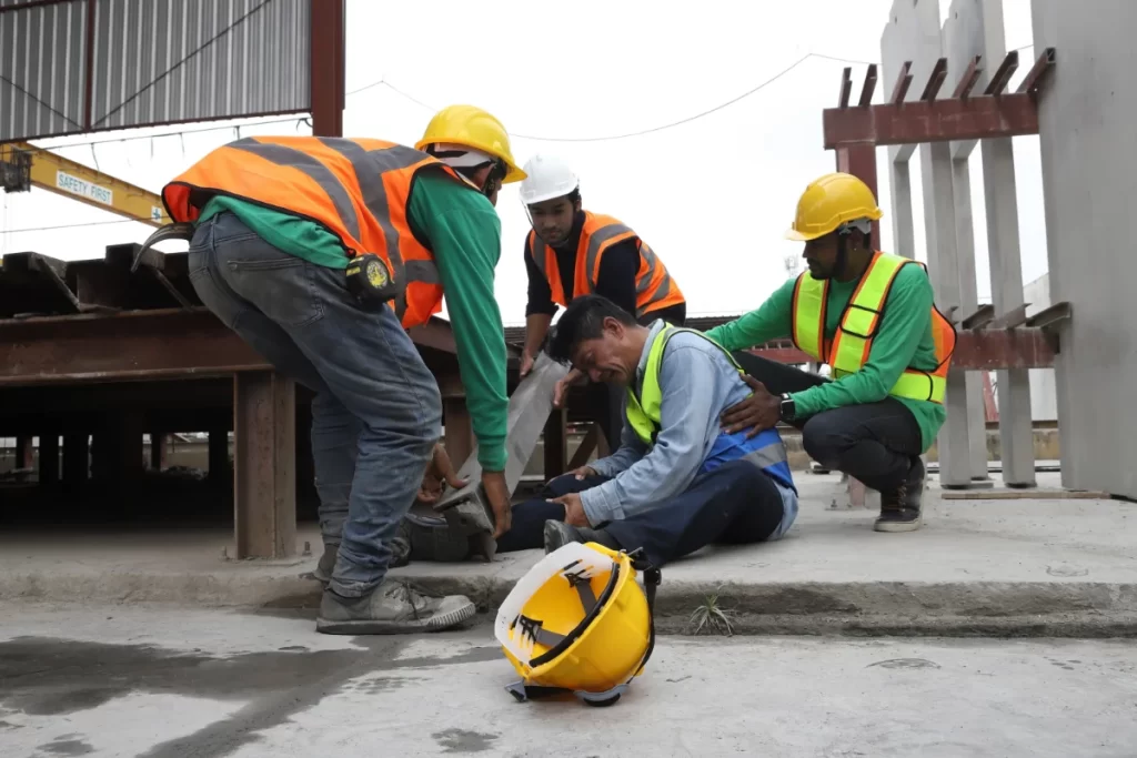 Injured construction worker on a jobsite, illustrating workers compensation exposure